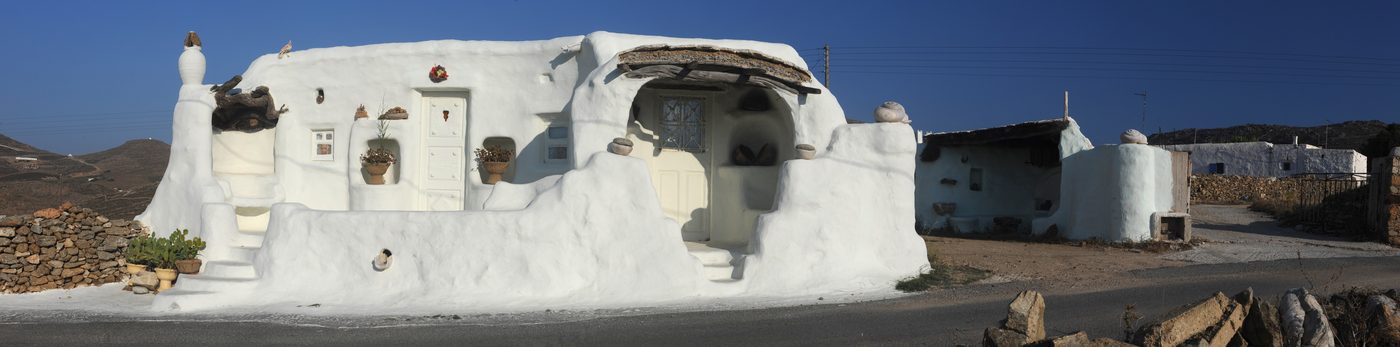 Panoramic view of Mykonos town harbour with the island beyond
