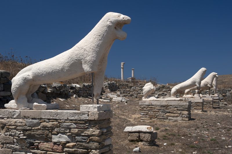 Ancient marble lions guard the terrace on the historic Delos island in Greece.