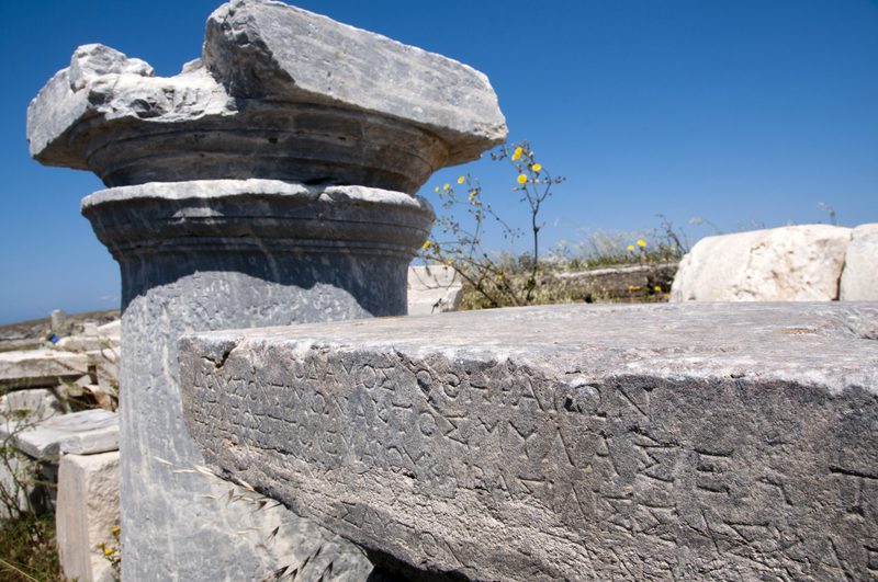 Ancient ruins and columns stand in the sun on the Greek island of Delos.