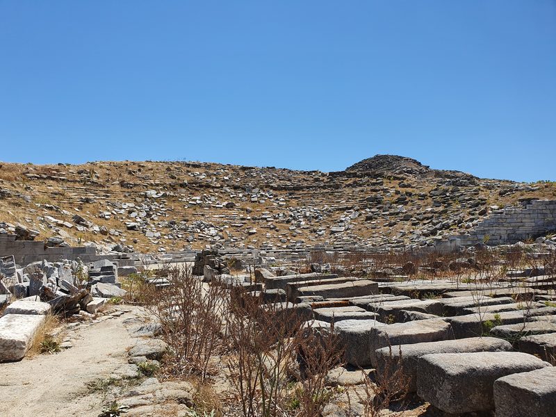 The tiered stone seating of the ancient theatre of Delos, built into the hillside