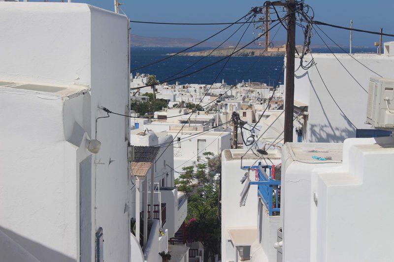 A serene view of the Mykonos port with sea buses docked.