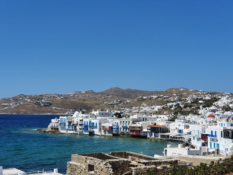 Looking down over Little Venice and Mykonos town, with the harbour and hillside houses stretching into the distance