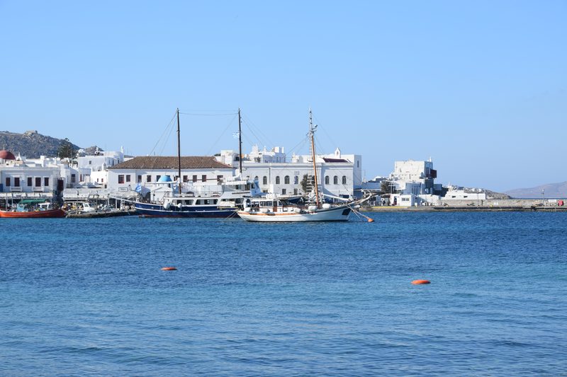Aerial view of Mykonos town with white buildings and blue rooftops.