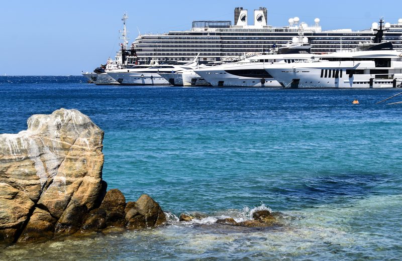 Several ships docked along the picturesque coast of Mykonos, Greece.