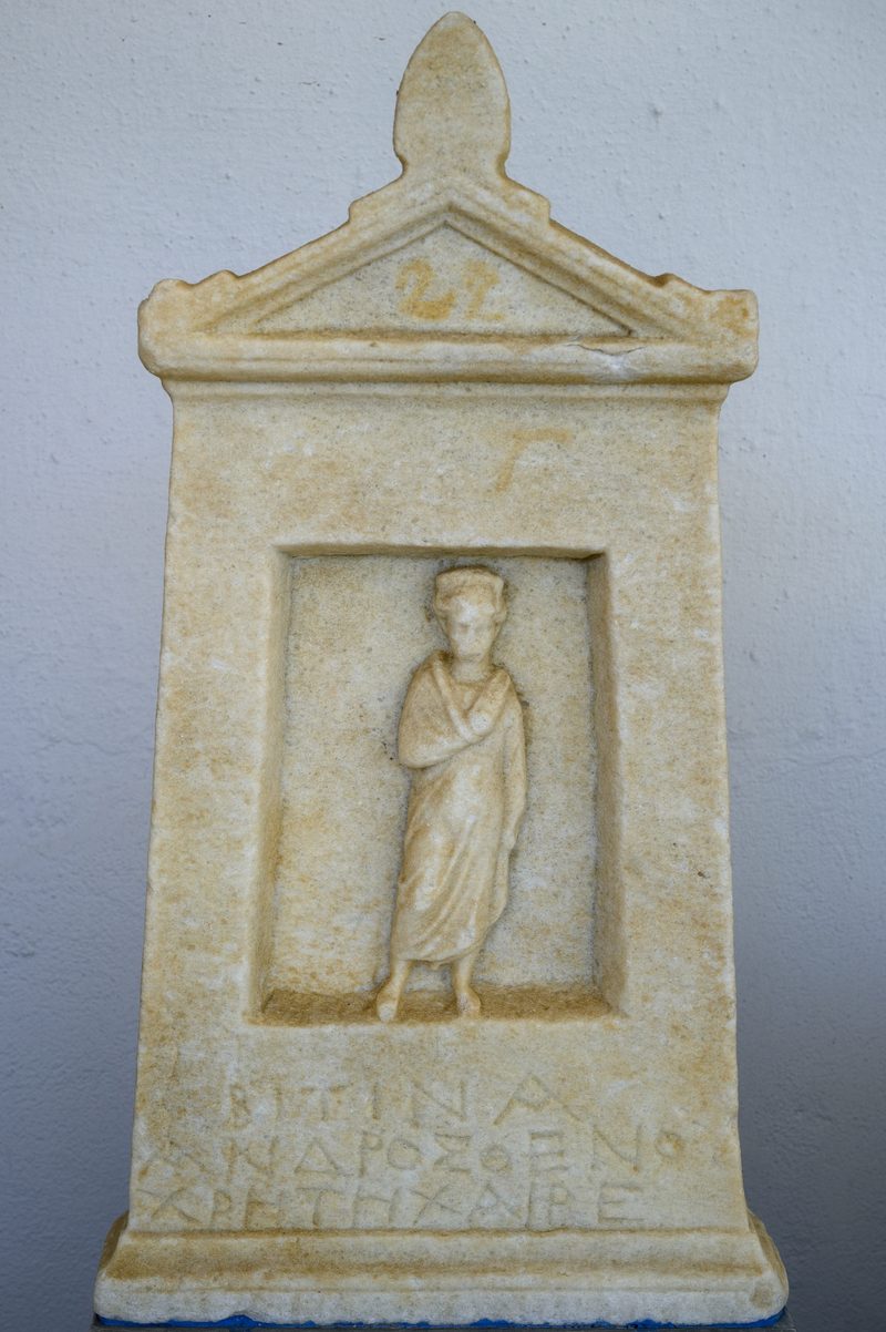 Ancient grave stele depicting a farewell scene at the Archaeological Museum of Mykonos.