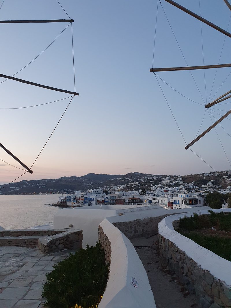 Mykonos town and the Little Venice waterfront seen from the windmills hill at sunset