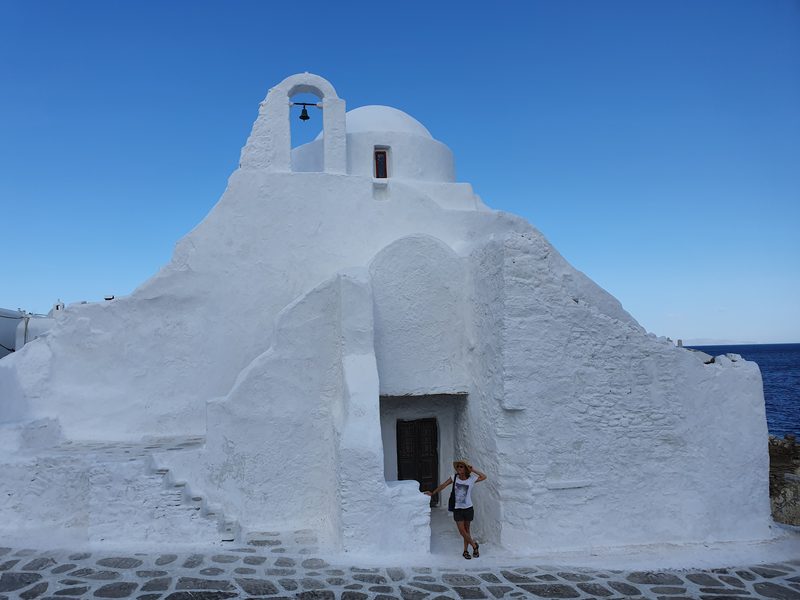 The whitewashed Panagia Paraportiani church beside the sea in Mykonos town