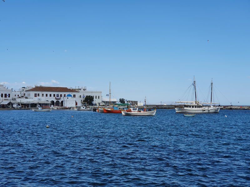 Small wooden fishing boats moored in the old port of Mykonos town