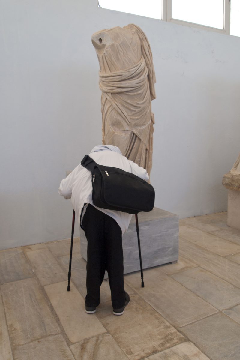 A vibrant beach scene with people enjoying the sun and sea in Mykonos, Greece.