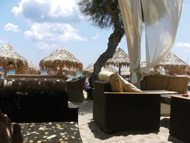 A serene beach scene with clear blue waters and white sand on Paradise Beach, Mykonos.