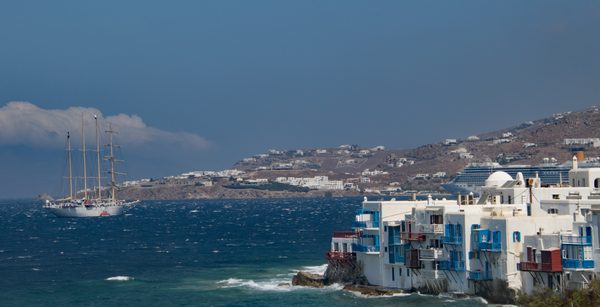A boat along the dramatic south coast of Mykonos island