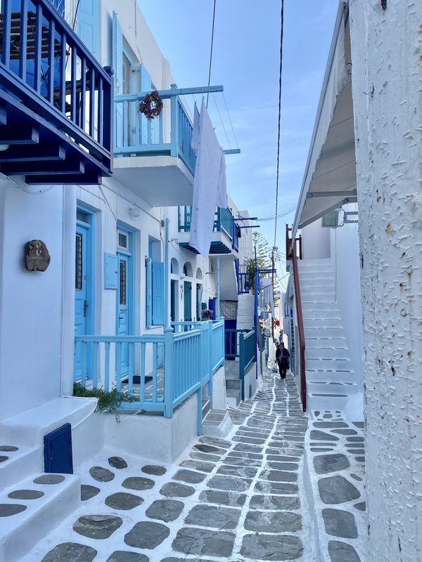 A whitewashed alley with vibrant bougainvillea in Mykonos town