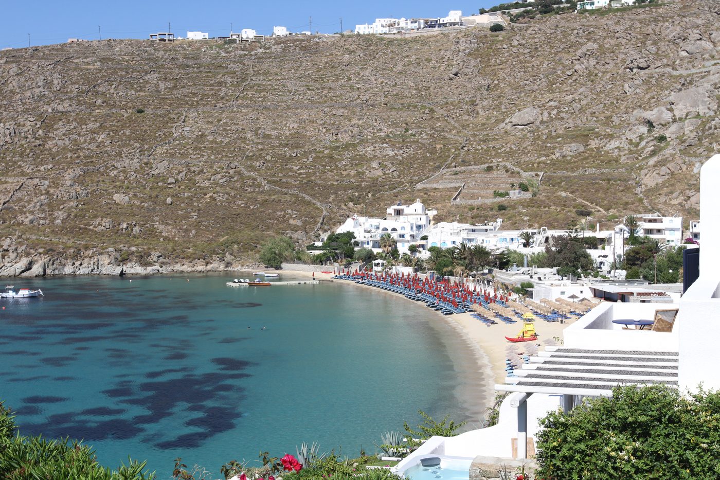 The popular sandy beach of Platis Gialos with sunbeds and calm water, Mykonos