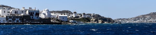 Fishing boats and yachts in Mykonos harbour with the town behind